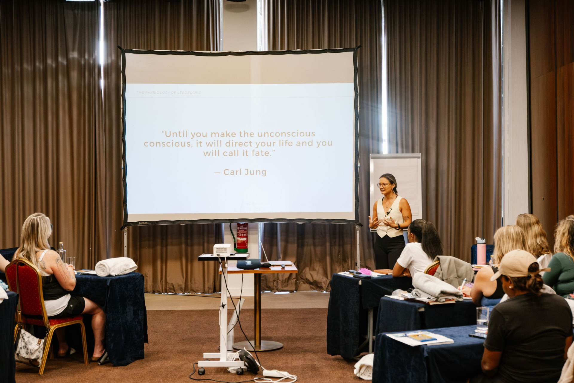 Izabella teaching a workshop beside a projected Carl Jung quote