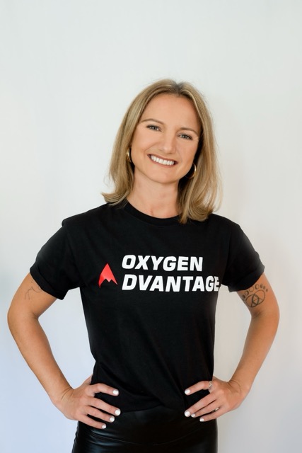 Izabella standing with her hands on her hips, wearing an Oxygen Advantage t-shirt